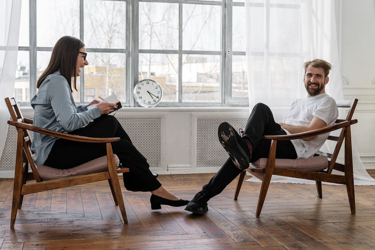 our-services-03 Counselor and client in a positive therapy session in a well-lit room.