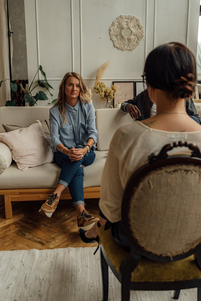 our-services-02 A therapist and client in discussion during a cozy indoor session highlighting mental health.